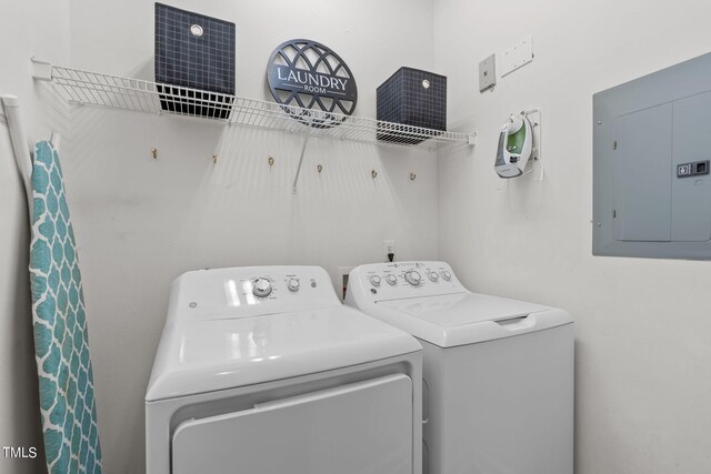 clothes washing area with electric panel and independent washer and dryer