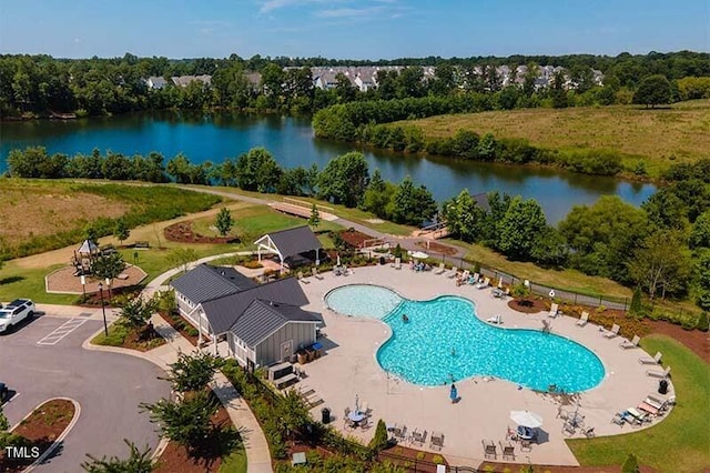 view of swimming pool featuring a water view and a patio area