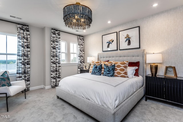 carpeted bedroom featuring a chandelier