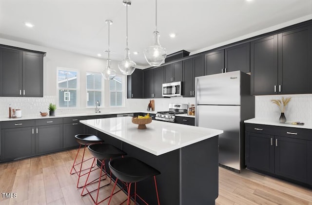 1170 Holding Village Way, Wake Forest, NC 27587 - kitchen with stainless steel appliances, recessed lighting, a kitchen bar, a center island, and tasteful backsplash