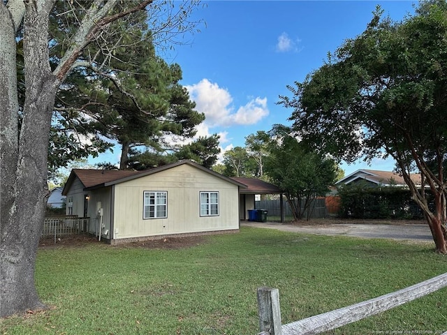 view of side of home featuring a lawn