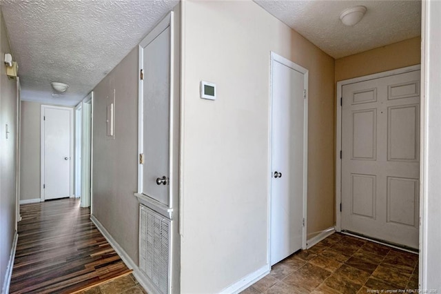 hallway with a textured ceiling