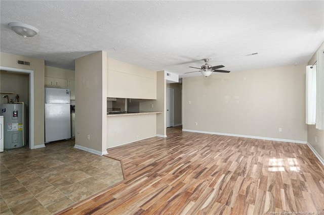 unfurnished living room with a textured ceiling, light hardwood / wood-style flooring, ceiling fan, and water heater