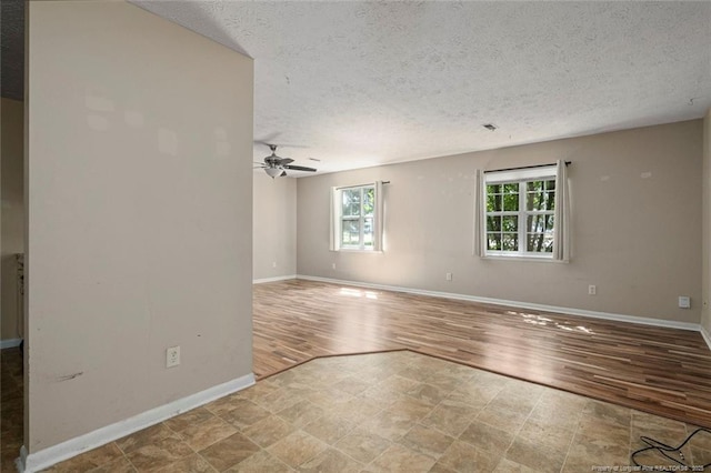 spare room featuring ceiling fan, a textured ceiling, and light hardwood / wood-style flooring