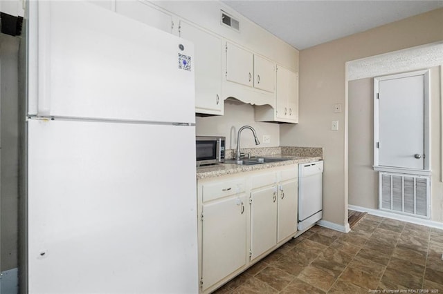 kitchen featuring white cabinetry, white appliances, and sink