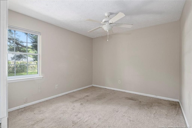 carpeted empty room featuring a textured ceiling and ceiling fan