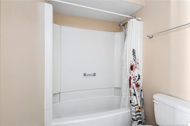 bathroom with toilet, a textured ceiling, and shower / tub combo with curtain