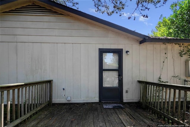 view of exterior entry with a wooden deck