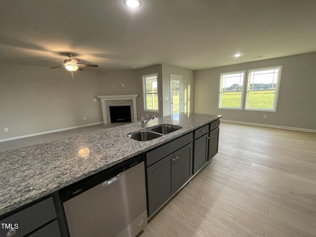 53 Grace Ridge Ct, Benson, NC 27504 - kitchen featuring stainless steel dishwasher, open floor plan, ceiling fan, light stone counters, and a sink