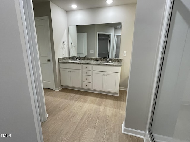 53 Grace Ridge Ct, Benson, NC 27504 - bathroom with double vanity, baseboards, a sink, and wood finished floors