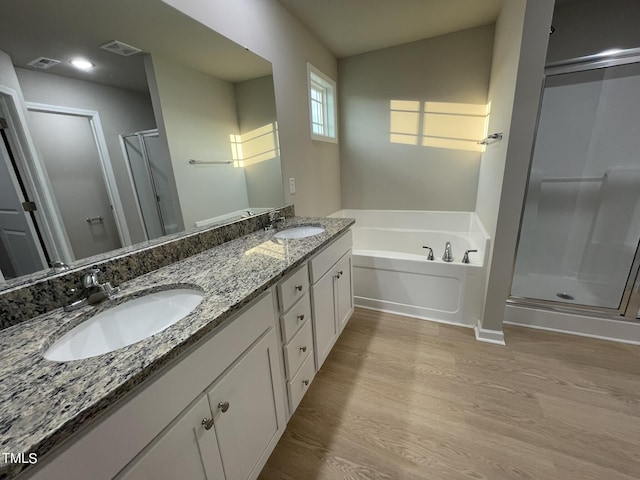 53 Grace Ridge Ct, Benson, NC 27504 - full bath featuring wood finished floors, a sink, a bath, and a stall shower