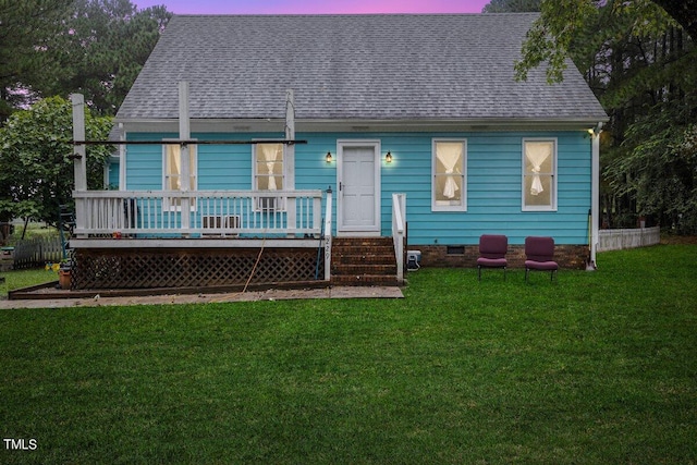 view of front facade featuring a wooden deck and a yard