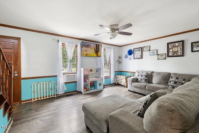 living room with ceiling fan, ornamental molding, a textured ceiling, and hardwood / wood-style floors