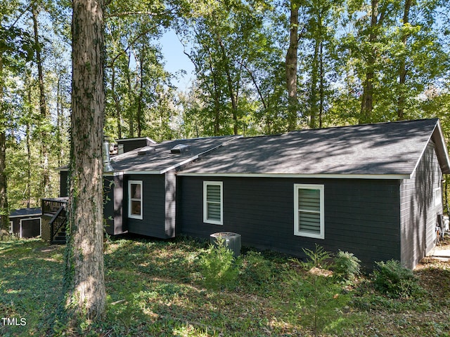 exterior space with cooling unit and a wooden deck