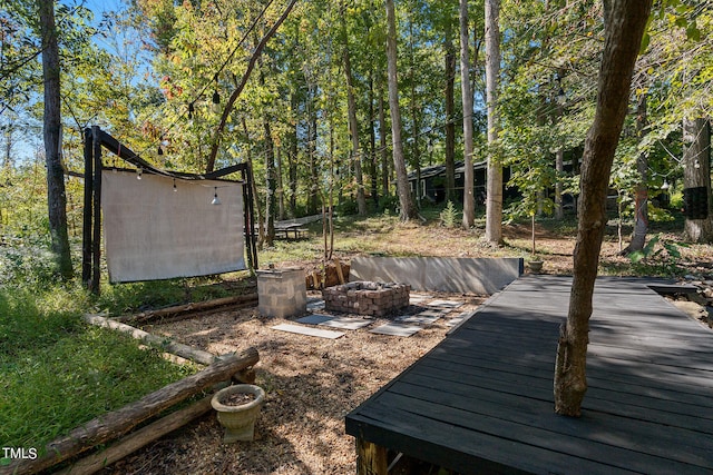 view of yard featuring a fire pit and a wooden deck