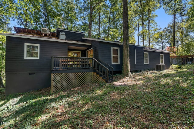 back of property featuring a wooden deck and central AC