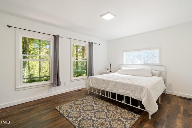 bedroom with dark hardwood / wood-style flooring