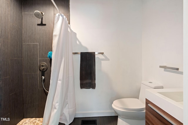 bathroom featuring toilet, a shower with curtain, and vanity