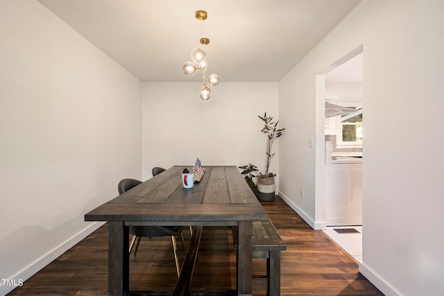 unfurnished dining area featuring dark wood-type flooring and a chandelier