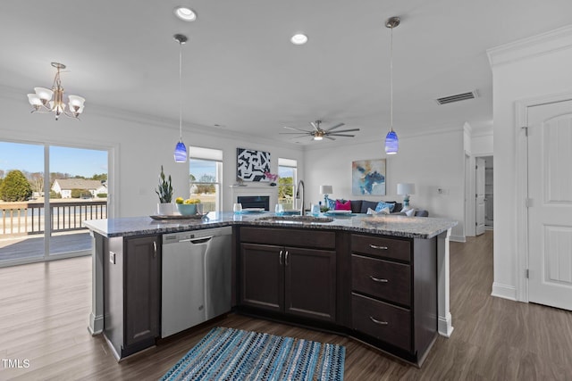 kitchen featuring dishwasher, visible vents, open floor plan, a sink, and dark brown cabinetry