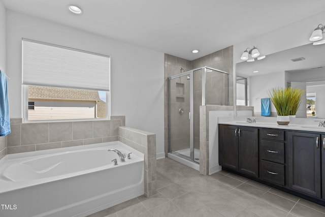 full bathroom with a bath, a healthy amount of sunlight, double vanity, and a sink