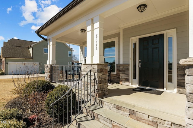 view of exterior entry with a porch and stone siding