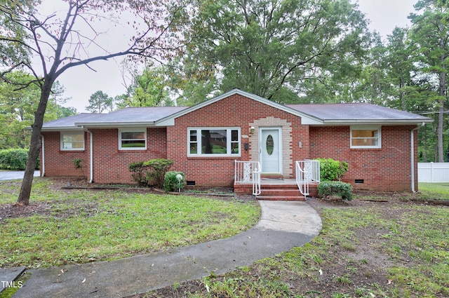 ranch-style home with crawl space, fence, a front lawn, and brick siding