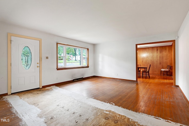 foyer entrance featuring wood-type flooring and baseboards