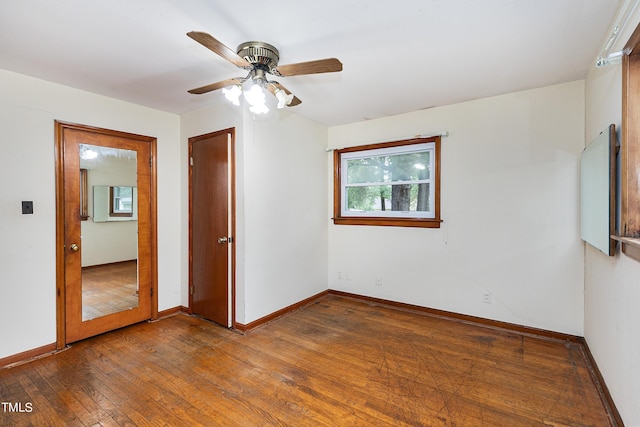 unfurnished room with hardwood / wood-style flooring and baseboards