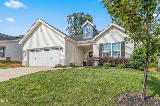 view of front of home with a garage and a front lawn