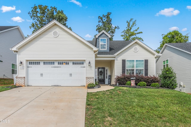 view of front of property featuring a garage and a front lawn