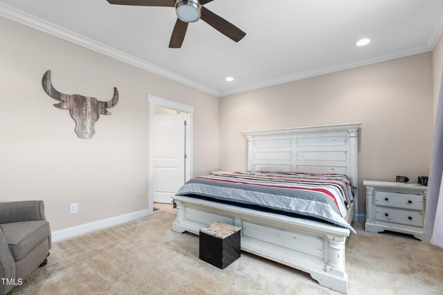 carpeted bedroom featuring ceiling fan and crown molding