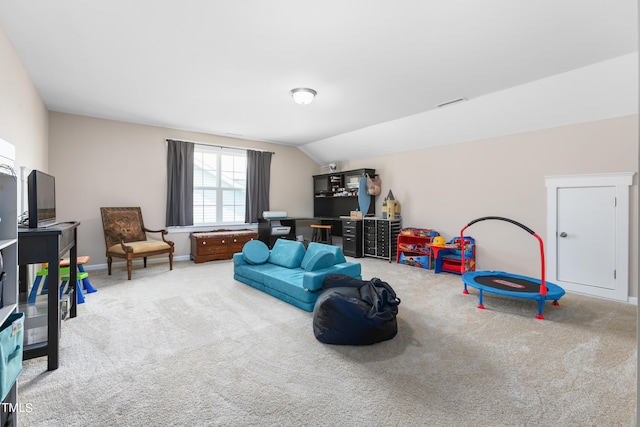 recreation room featuring carpet floors and vaulted ceiling