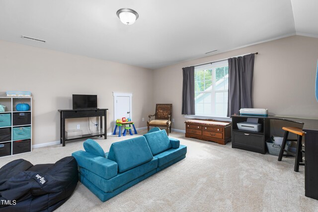 carpeted living room with vaulted ceiling