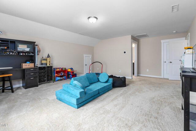 carpeted living room with vaulted ceiling