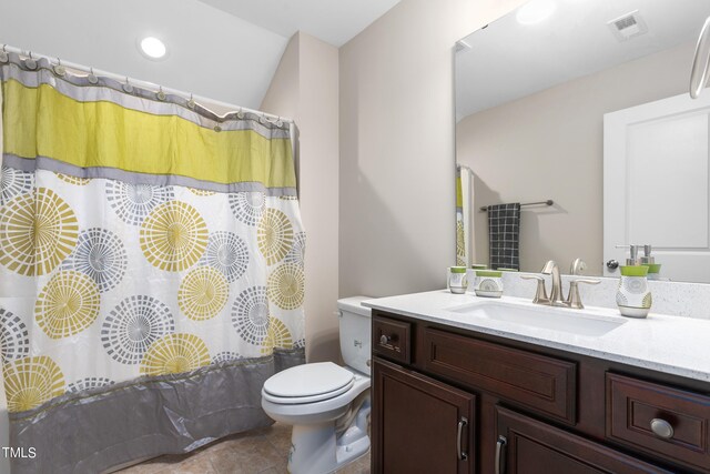 bathroom with curtained shower, vanity, toilet, and tile patterned floors