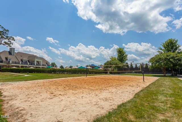 view of property's community featuring volleyball court and a yard