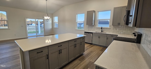 kitchen featuring pendant lighting, sink, gray cabinets, stainless steel appliances, and a kitchen island