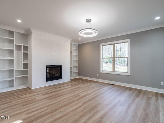 unfurnished living room featuring light hardwood / wood-style flooring and crown molding