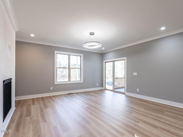 unfurnished living room featuring crown molding and light wood-type flooring