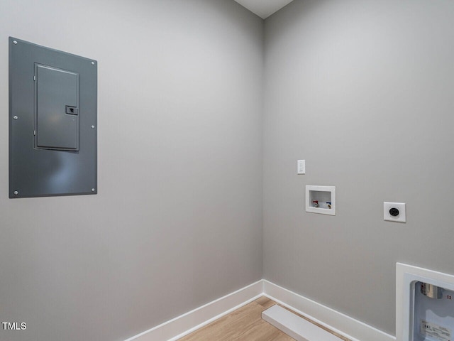 laundry room with hookup for a washing machine, electric panel, hardwood / wood-style flooring, and electric dryer hookup