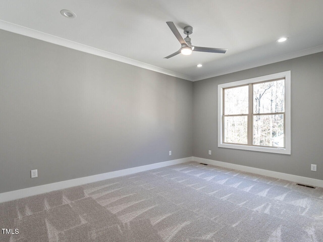 unfurnished room featuring light carpet, ceiling fan, and crown molding