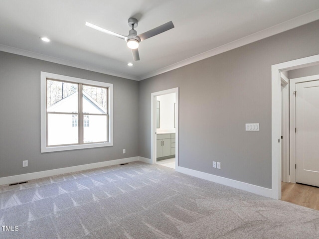 unfurnished bedroom with light colored carpet, ensuite bath, ceiling fan, and crown molding