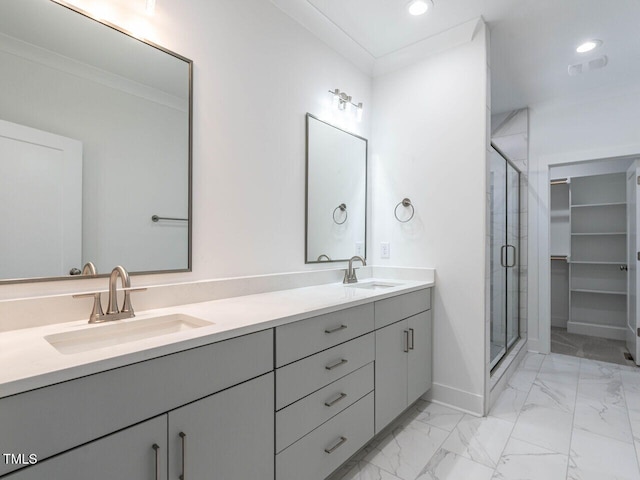 bathroom featuring vanity, a shower with door, and crown molding