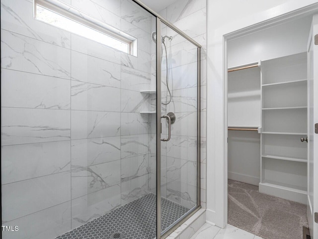 bathroom featuring plenty of natural light and walk in shower