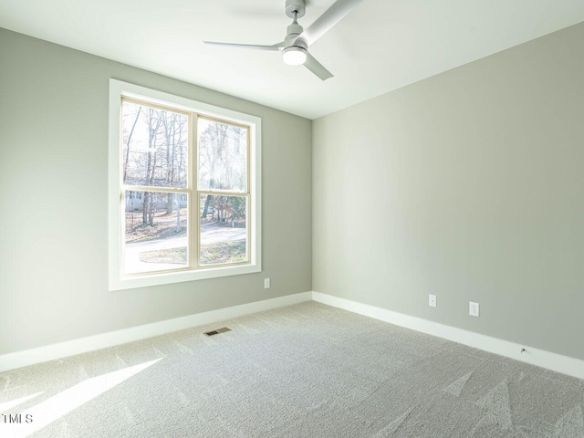 carpeted empty room featuring ceiling fan