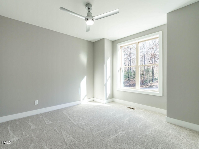 carpeted empty room featuring ceiling fan