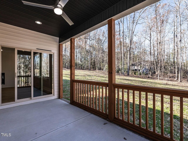 unfurnished sunroom with ceiling fan