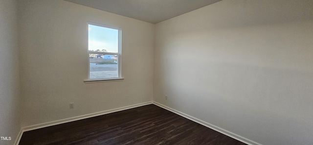 spare room featuring dark wood-type flooring