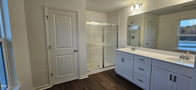 bathroom featuring vanity, a shower with door, and hardwood / wood-style floors